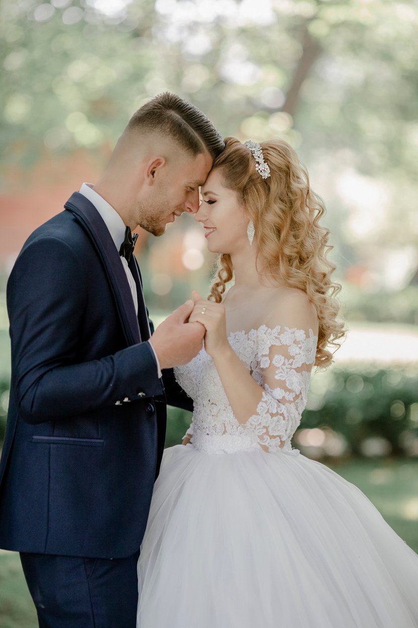 Selective Focus Photo of Groom and Bride Facing Each Other